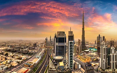 Sweeping panoramic view of the Dubai skyline at sunset, featuring the Burj Khalifa and major highways, signifying that the best movers and packers in Dubai serve all local areas.