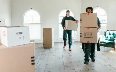 Apartment movers in Dubai from dxbmovershub carrying moving boxes into a new apartment